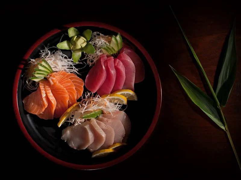 Three kinds of fresh sashimi served with lemon and radish at Sushi Feast AYCE, a Japanese Restaurant in Ocala